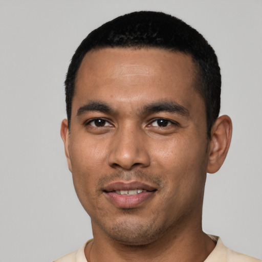 Joyful latino young-adult male with short  black hair and brown eyes