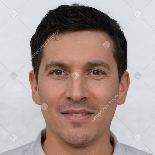 Joyful white young-adult male with short  brown hair and brown eyes