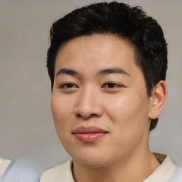 Joyful asian young-adult male with short  black hair and brown eyes