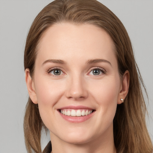 Joyful white young-adult female with long  brown hair and grey eyes