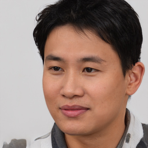 Joyful asian young-adult male with short  black hair and brown eyes