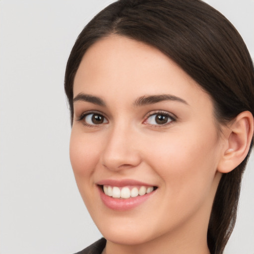 Joyful white young-adult female with long  brown hair and brown eyes