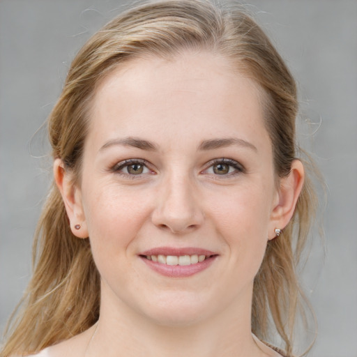 Joyful white young-adult female with medium  brown hair and blue eyes