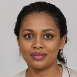 Joyful black young-adult female with medium  brown hair and brown eyes