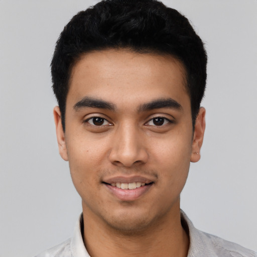 Joyful latino young-adult male with short  black hair and brown eyes