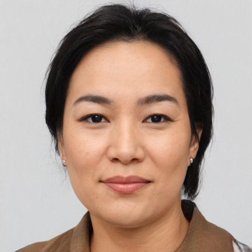 Joyful asian young-adult female with medium  black hair and brown eyes