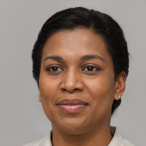 Joyful latino adult female with short  black hair and brown eyes