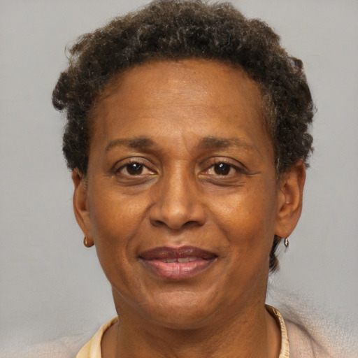 Joyful black adult female with short  brown hair and brown eyes