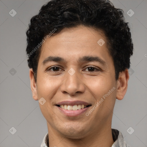 Joyful latino young-adult male with short  brown hair and brown eyes