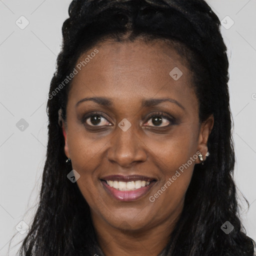 Joyful black young-adult female with long  brown hair and brown eyes