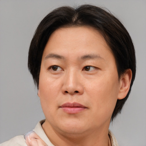 Joyful asian adult female with short  brown hair and brown eyes