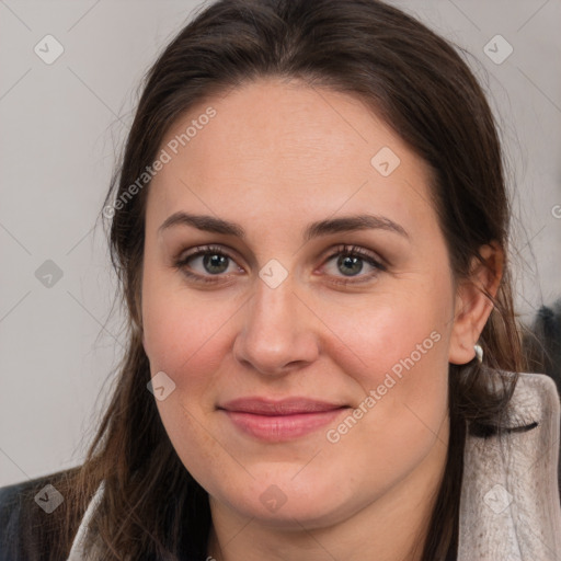 Joyful white adult female with long  brown hair and brown eyes