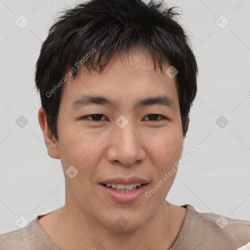 Joyful asian young-adult male with short  brown hair and brown eyes