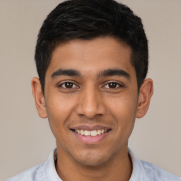 Joyful latino young-adult male with short  black hair and brown eyes