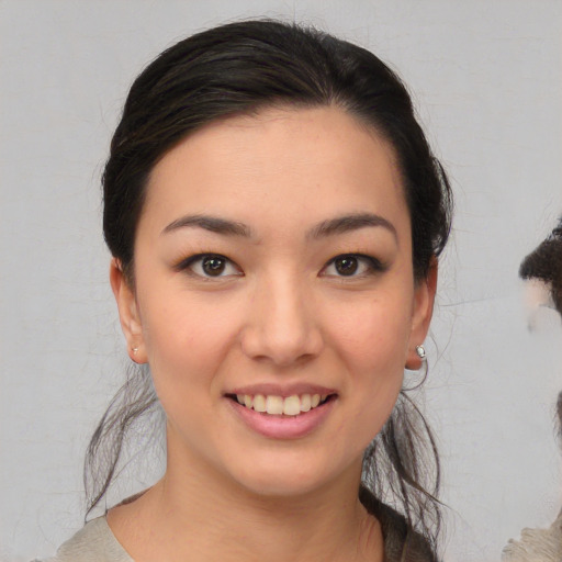 Joyful white young-adult female with medium  black hair and brown eyes