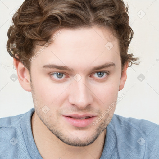 Joyful white young-adult male with short  brown hair and blue eyes