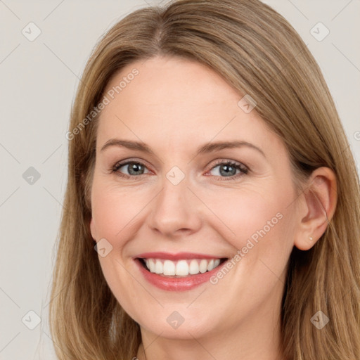 Joyful white young-adult female with long  brown hair and green eyes