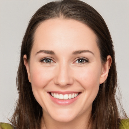 Joyful white young-adult female with long  brown hair and brown eyes