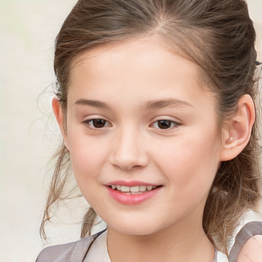 Joyful white child female with medium  brown hair and brown eyes