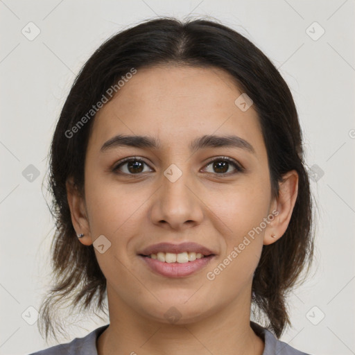 Joyful latino young-adult female with medium  brown hair and brown eyes