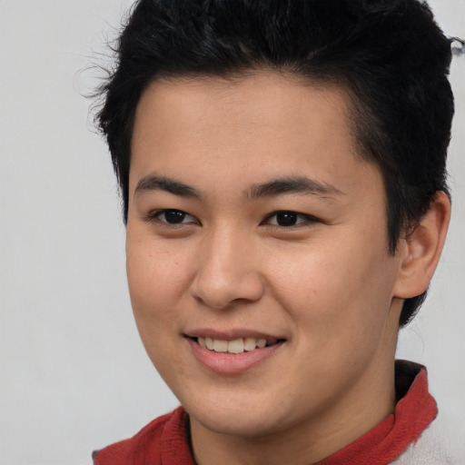 Joyful asian young-adult male with short  brown hair and brown eyes