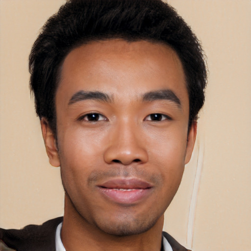 Joyful latino young-adult male with short  black hair and brown eyes