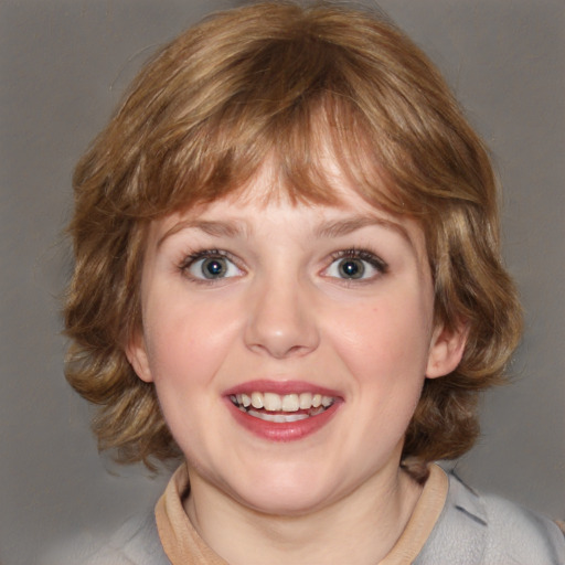 Joyful white young-adult female with medium  brown hair and blue eyes