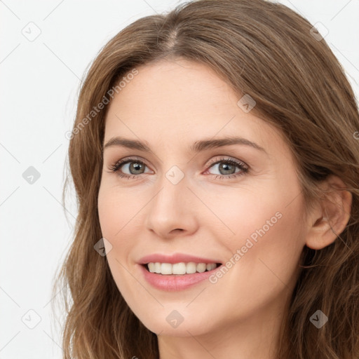 Joyful white young-adult female with long  brown hair and green eyes