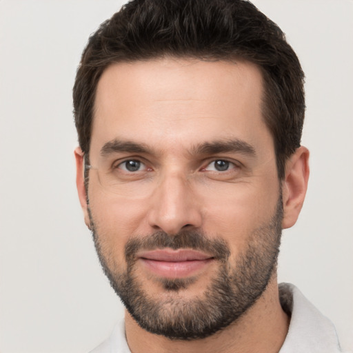 Joyful white young-adult male with short  brown hair and brown eyes