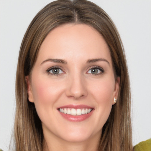 Joyful white young-adult female with long  brown hair and green eyes