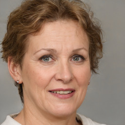 Joyful white adult female with medium  brown hair and blue eyes