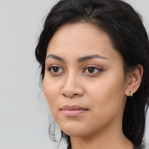Joyful asian young-adult female with long  brown hair and brown eyes