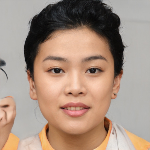 Joyful asian young-adult female with short  brown hair and brown eyes