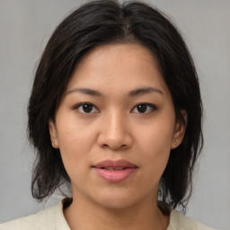 Joyful asian young-adult female with medium  brown hair and brown eyes