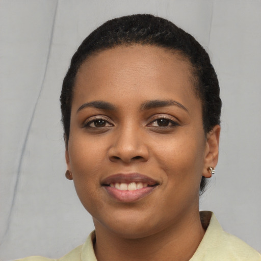 Joyful latino young-adult female with short  black hair and brown eyes