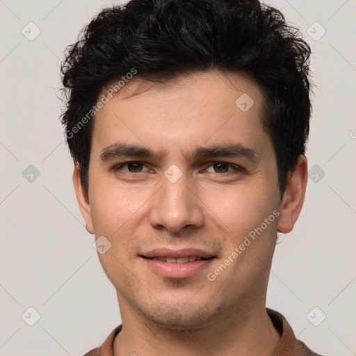 Joyful white young-adult male with short  black hair and brown eyes