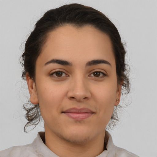 Joyful latino young-adult female with medium  brown hair and brown eyes