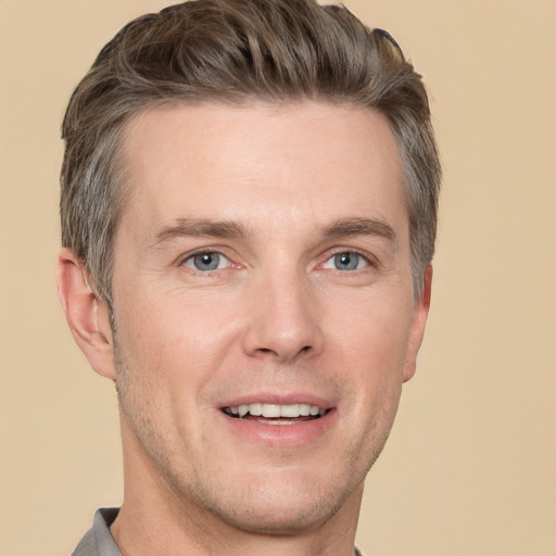 Joyful white adult male with short  brown hair and grey eyes