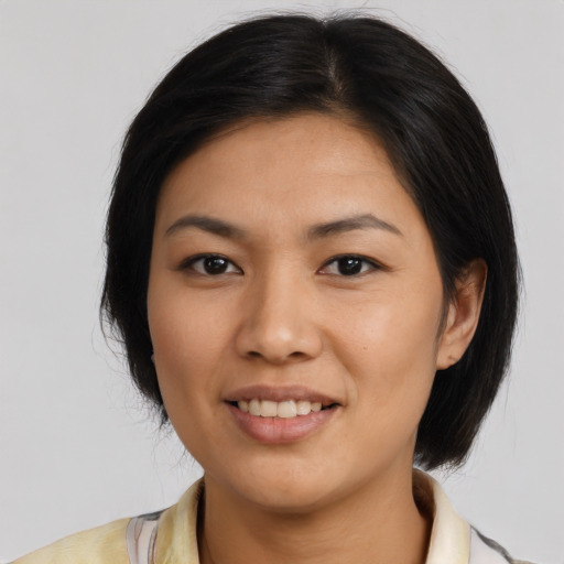 Joyful asian young-adult female with medium  black hair and brown eyes