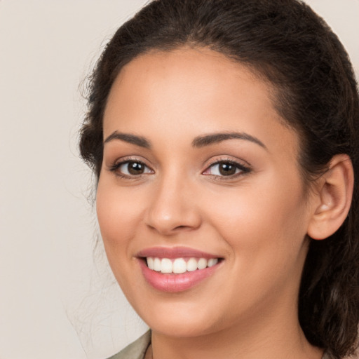 Joyful white young-adult female with long  brown hair and brown eyes