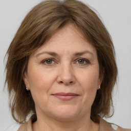 Joyful white adult female with medium  brown hair and grey eyes