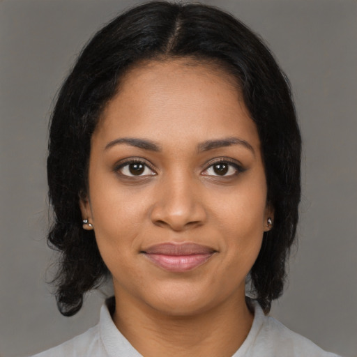 Joyful black young-adult female with medium  black hair and brown eyes