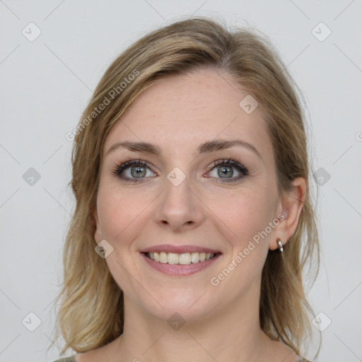 Joyful white young-adult female with medium  brown hair and blue eyes