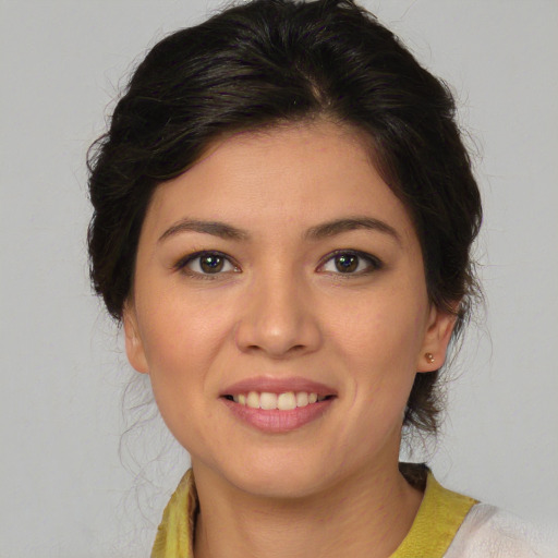 Joyful latino young-adult female with medium  brown hair and brown eyes