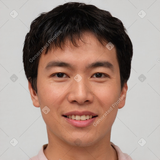 Joyful asian young-adult male with short  brown hair and brown eyes