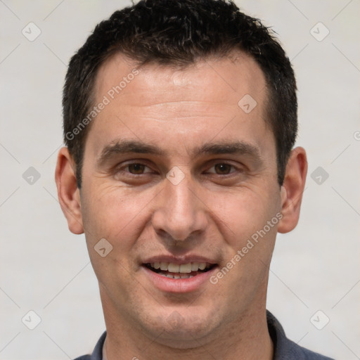 Joyful white adult male with short  brown hair and brown eyes