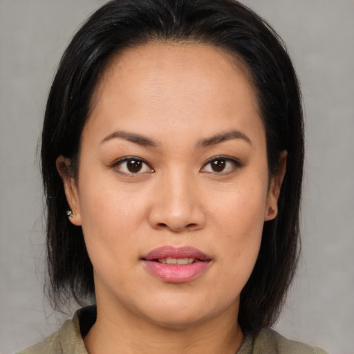 Joyful asian young-adult female with medium  brown hair and brown eyes