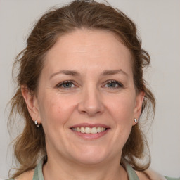 Joyful white adult female with medium  brown hair and grey eyes