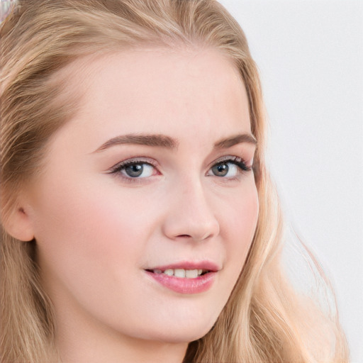 Joyful white young-adult female with long  brown hair and blue eyes