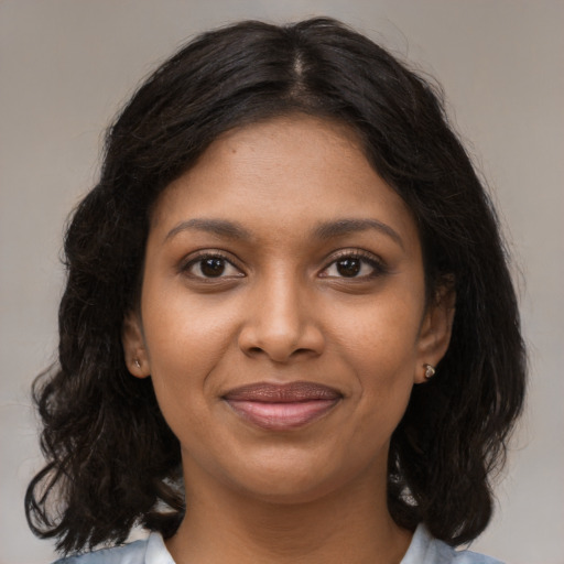 Joyful black young-adult female with medium  brown hair and brown eyes